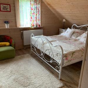 a bedroom with a white bed in a attic at UDany Weekend in Ustrzyki Dolne