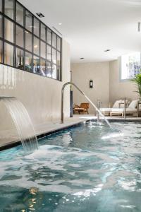 a pool with water fountain in a hotel room at Ayala 63 - THE ARC COLLECTION in Madrid