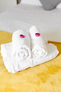 two towels sitting on top of a bed at Comfortable Liverpool Townhouse - FREE parking in Liverpool