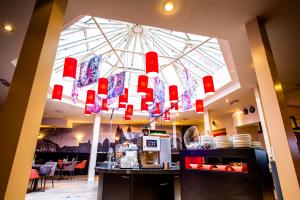 a restaurant with a large glass ceiling with red lights at Bastion Hotel Maastricht Centrum in Maastricht