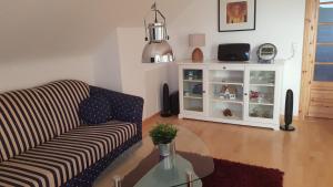 un soggiorno con un divano e un tavolo di vetro di Ferienwohnung Wichmannsberg a Hameln