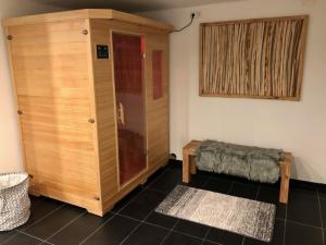 a room with a large wooden cabinet and a bed at Ferienwohnung Vergissmeinnicht in Osburg
