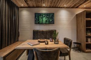 a dining room with a wooden table and chairs at Apartment Alpinflair 1 in Kaprun