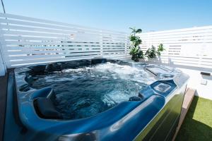 a hot tub in the middle of a building at Magno Apartments Alameda 1851 Penthouse - Private terrace and jacuzzi in Seville