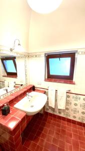 bagno con lavandino bianco e finestra di TGI Dammusi Preziosi a Pantelleria