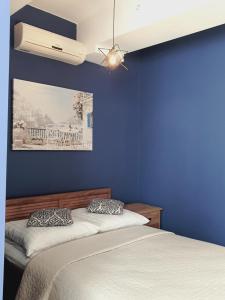 a blue bedroom with two beds and a ceiling fan at Apartament Stojałowskiego 35 in Bielsko-Biała
