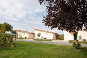 a row of white houses on a road at Villas Finca La Emperatriz in Baños de Rioja