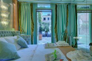 a bedroom with a large white bed and a window at GranDELUX-Canal in Venice