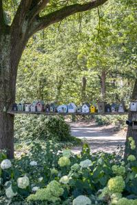 a toy train sitting on a bridge in a park at Restaurant & Hotel Hoog Holten in Holten