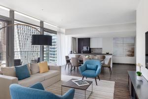 a living room with a couch and chairs at Jumeirah Living Marina Gate Hotel and Apartments in Dubai