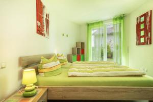 a bedroom with a large bed with a window at Ferienwohnung Orchidee in Sipplingen
