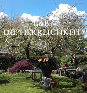 a sign that reads die hierarcheenth in a park at B&B Die Herrlichkeit in Lage