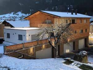 une maison avec de la neige devant elle dans l'établissement Gästehaus Kessler, à Gaschurn