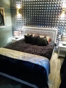 a bedroom with a large bed with a large headboard at Terra Rossa- clim- pieds dans l'eau in Conca