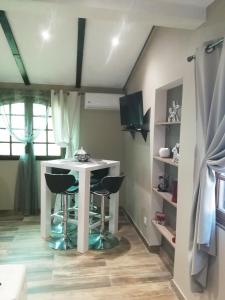 Una cocina con una mesa y taburetes en una habitación. en Terra Rossa- clim- pieds dans l'eau, en Conca