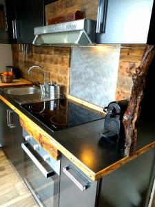 a kitchen with a stove and a sink in it at Terra Rossa- clim- pieds dans l'eau in Conca