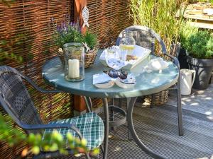 a table with glasses and a tray of food on a patio at Strandläufernest in Tinnum +12 photos