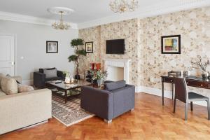 a living room with a couch and a table at Arlington House Apartments in London