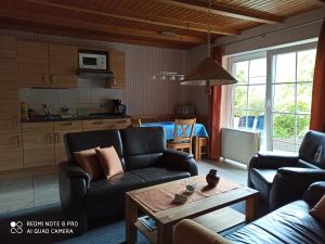 a living room with a couch and a table at Der Amboss in Wangerland