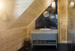 a bathroom with a sink and a staircase at Rezidencia Woodchalet in Veľká Lomnica +59 photos