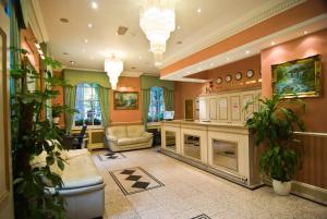 a large living room with a couch and a table at Alexandra Hotel in London