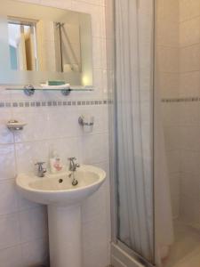 a bathroom with a sink and a shower at The Old Station House in Matlock