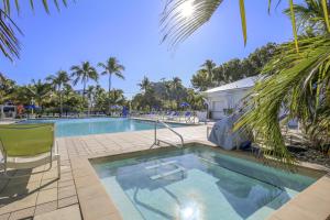 a swimming pool with a chair next to a resort at Vitamin Sea in Tavernier