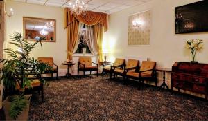a waiting room with chairs and a chandelier at Gleneagles - Albert Road in Blackpool +18 photos
