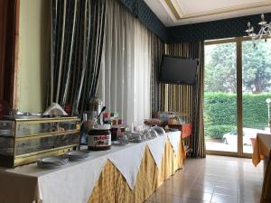 a table with plates on it in a room at Cristal Hotel in Manocalzati