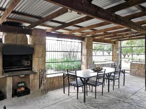 a patio with a table and chairs and a fireplace at Mountain Valley Stay - UNIT 4 in Nelspruit