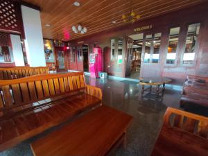 a room that has a lot of furniture in it at Riverfront Hotel Mukdahan in Mukdahan