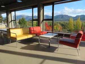 a room with chairs and a table with a view of mountains at Alberg la Bruna in Bellver de Cerdanya