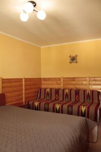 a bedroom with two beds and yellow walls at Dream House in Yaremche