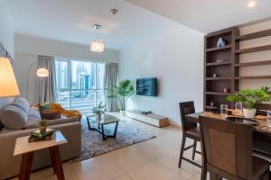 a living room with a couch and a table at GuestReady - Panoramic View of Dubai Skyline in Dubai