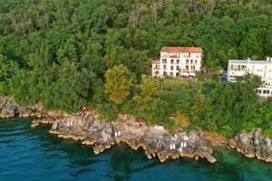 an aerial view of a house on an island in the water at Hotel Stanger in Lovran