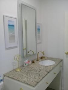 a bathroom with a sink and a mirror at Ocean Front Property - Villa 4 Aruba w pool view in Savaneta