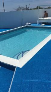 a blue and white swimming pool with a white border at Ocean Front Property - Villa 4 Aruba w pool view in Savaneta