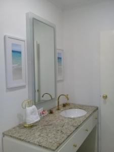 a bathroom with a sink and a mirror at Ocean Front Property - Villa 4 Aruba w pool view in Savaneta