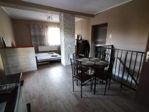 a dining room with a table and chairs in a room at Bella Vendégház in Etyek