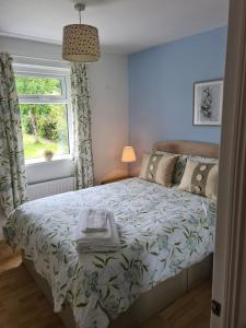 a bedroom with a bed and a window at Contractor Accommodation Antrim in Aldergrove