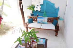 a blue bench sitting on a porch with a plant at Apartment Brazil Beach Front Paradise in Savaneta