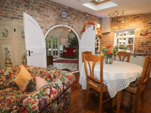 a living room with a couch and a table at Ash Tree Lodge in Hull