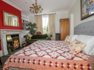 a bedroom with a large bed and a fireplace at Ash Tree Lodge in Hull