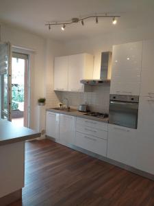 a kitchen with white cabinets and a counter top at Sesto Calende Centro in Sesto Calende