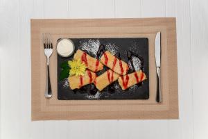 a plate of food with sushi on a table at Guest House Shale in Vinnytsya