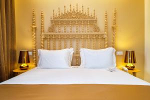 a bedroom with a large white bed with two lamps at Sintra Boutique Hotel in Sintra