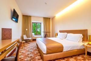a hotel room with a bed and a desk at Sintra Boutique Hotel in Sintra