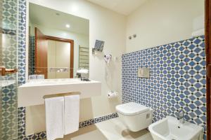 a bathroom with a toilet and a sink and a mirror at Sintra Boutique Hotel in Sintra