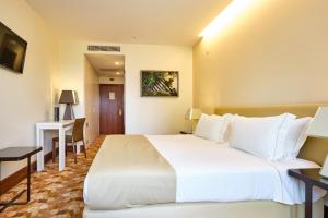 a large white bed in a hotel room at Sintra Boutique Hotel in Sintra