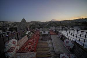 a balcony with chairs and a view of the city at Göreme Art Stone in Goreme